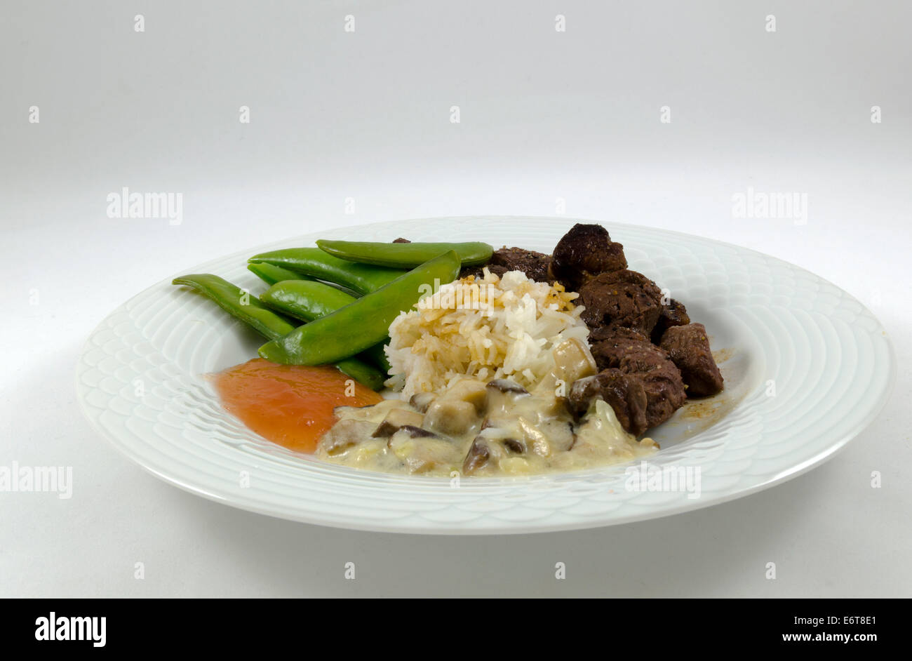 Rentier-Steak, Reis, Bohnen, Pilzen und Apfel-Gel isoliert auf weiss Stockfoto