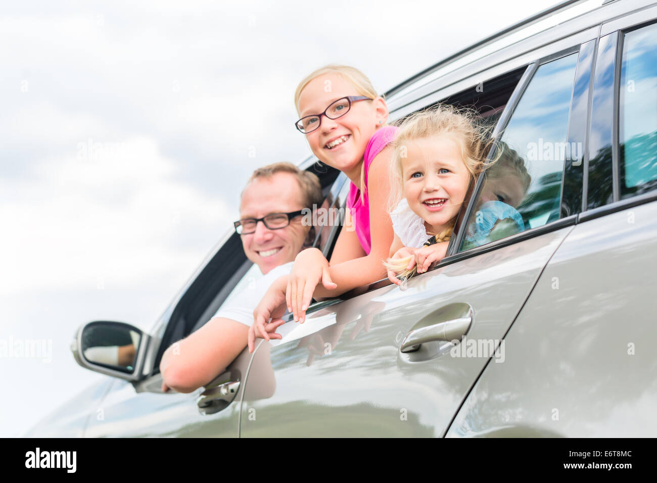 Familienauto - Vater mit Töchtern im Auto fahren Stockfoto