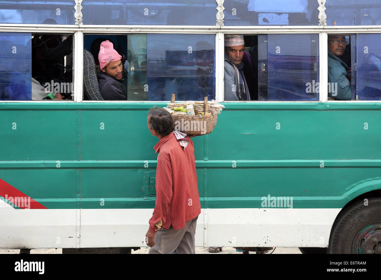 Straße Verkäufer verkauft Snacks für Passagiere auf lokale Busse in Damak, Nepal Stockfoto