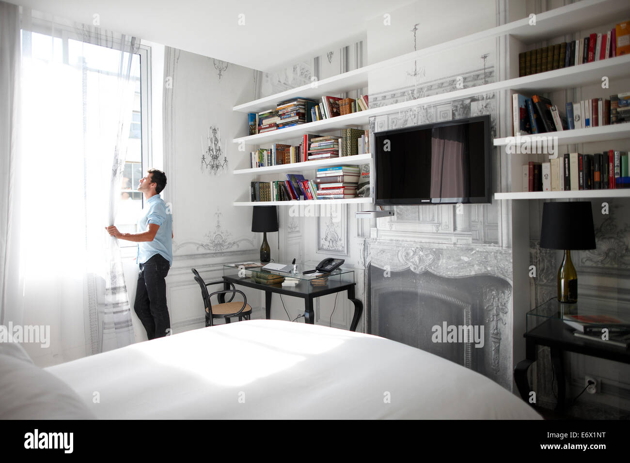 Mann aus einem Fenster in einer Hotelsuite, Paris, Frankreich Stockfoto