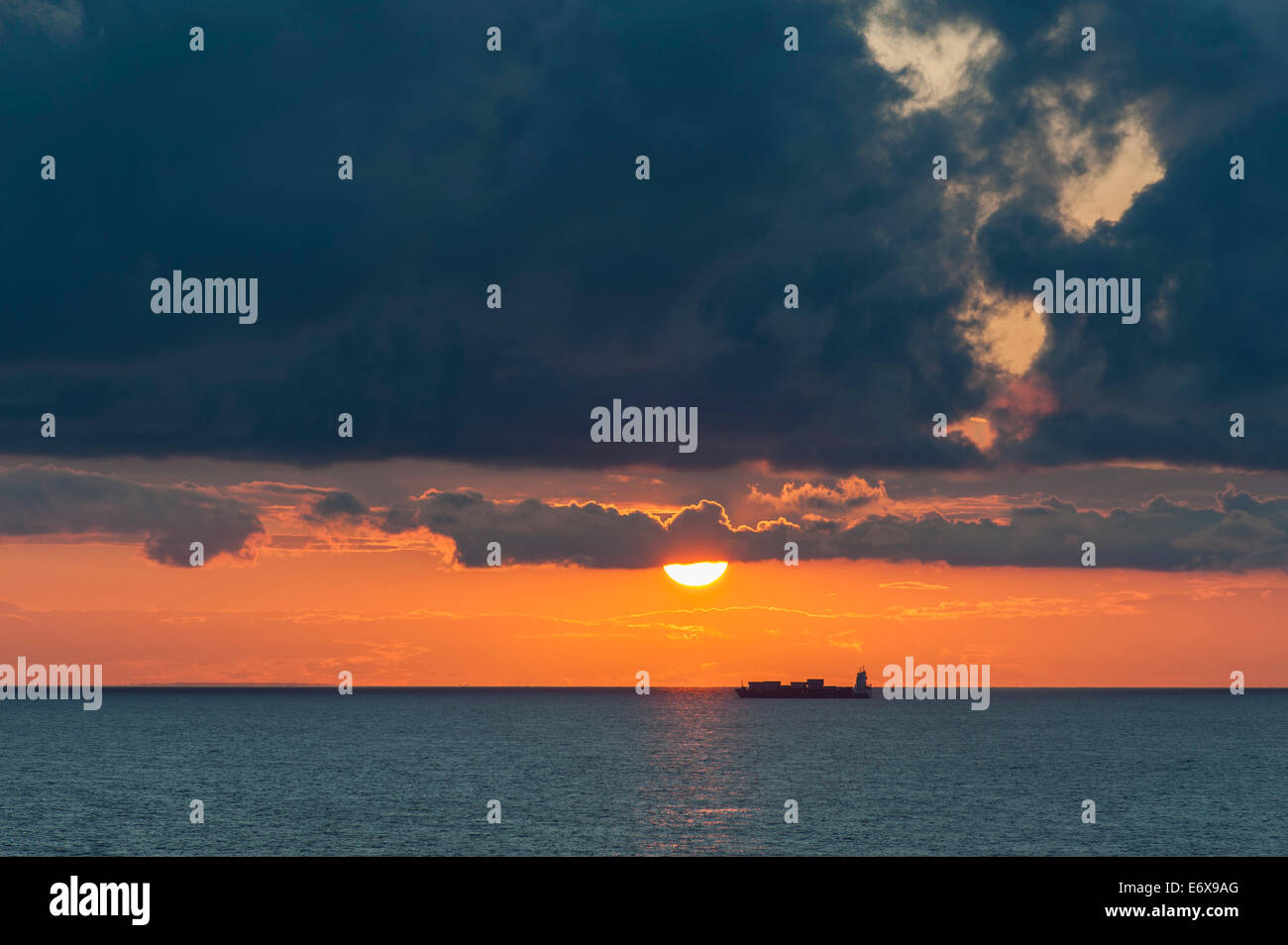 Ostsee bei Sonnenuntergang, Containerschiff auf der Rückseite, Wolken, aus der Insel Gotland, Schweden Stockfoto