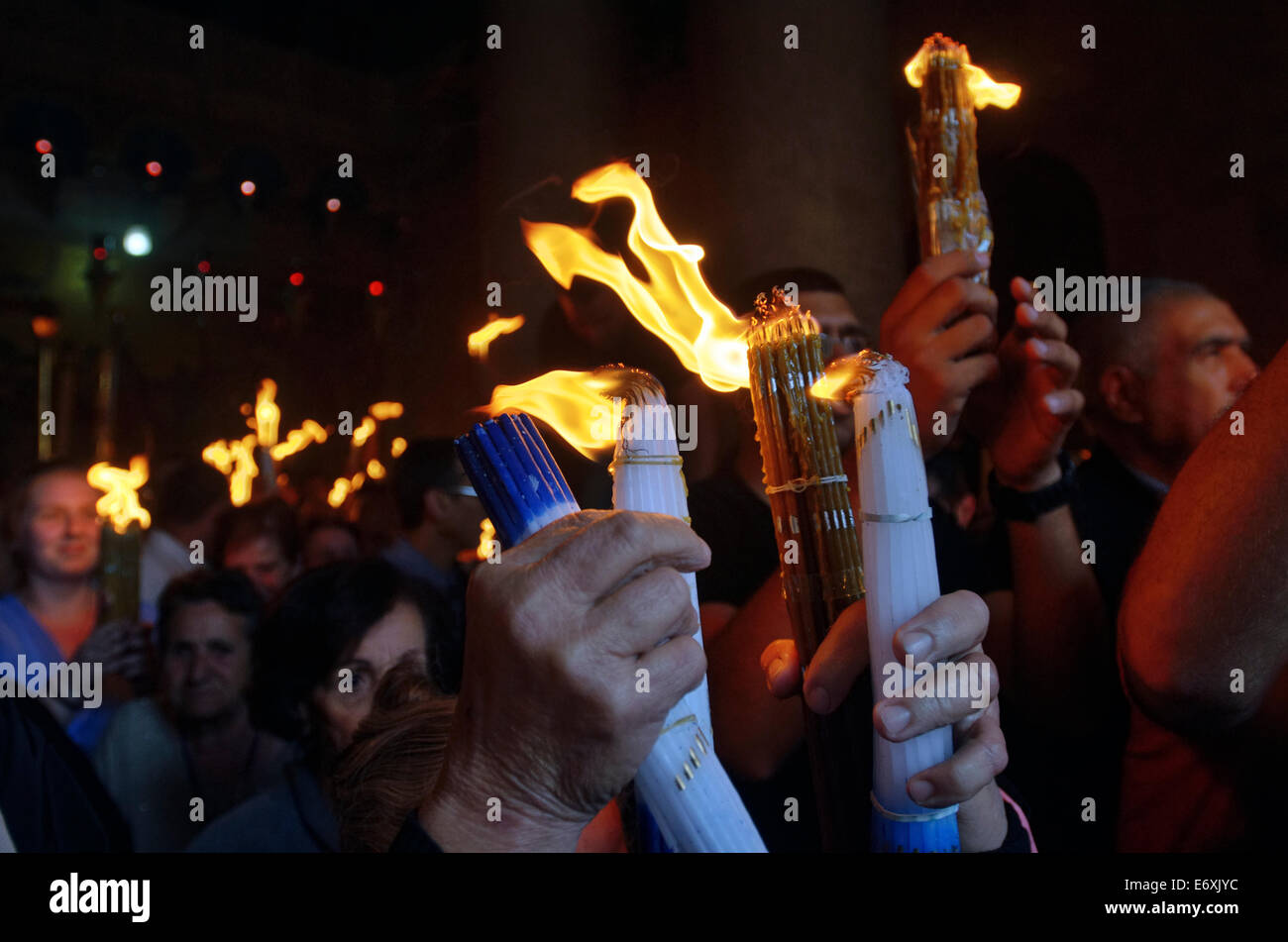 Menschen halten Kerzen mit dem Feuer in der Grabeskirche im Heiligen Feuer Zeremonie in Jerusalem, Israel Stockfoto