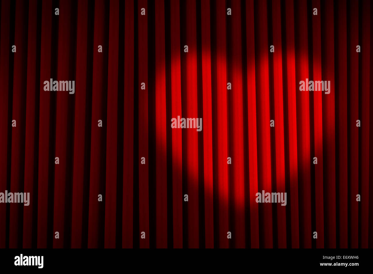 Roter Samtvorhang mit Herzen Spotlight. Stockfoto