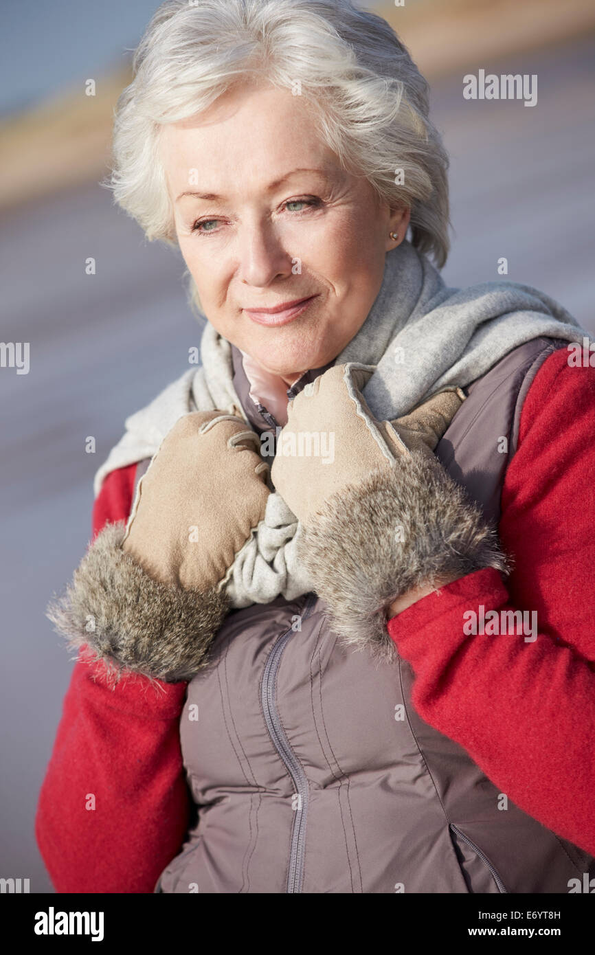 Senior Woman Walking On Winter Beach Stockfoto