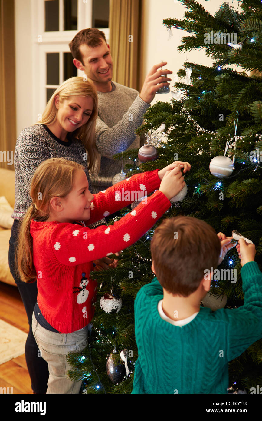 Familie dekorieren Weihnachtsbaum zu Hause zusammen Stockfoto