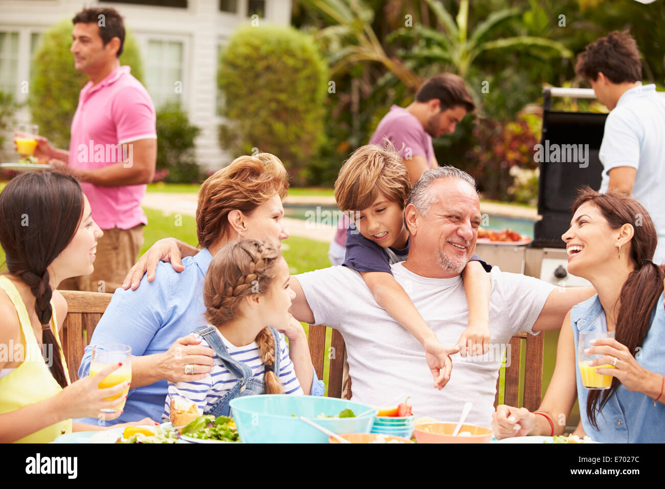 Multi-Generationen-Familie gemeinsame Mahlzeit im Garten genießen Stockfoto