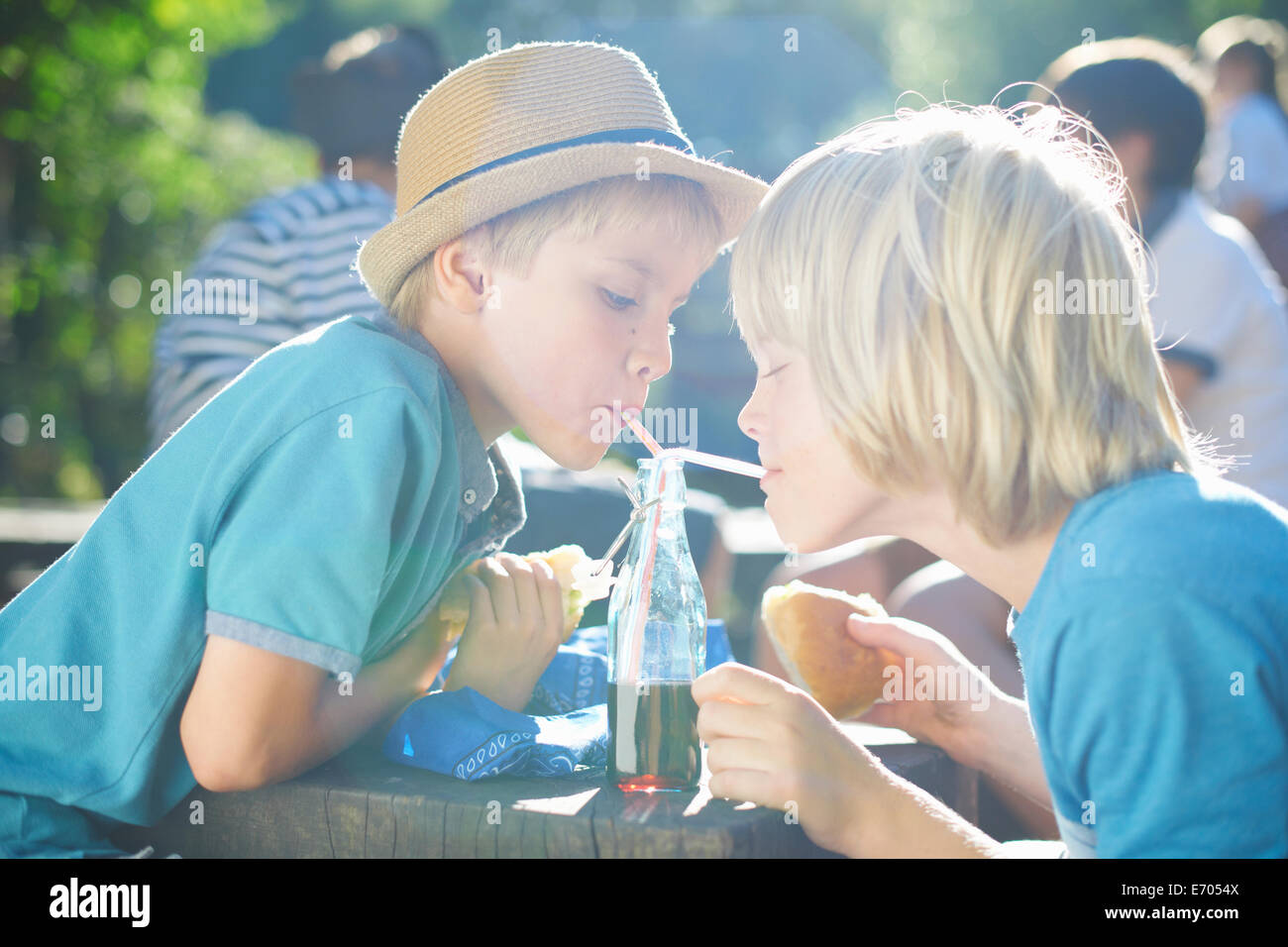 Zwei Jungen aus Flasche mit einem Strohhalm trinken Stockfoto