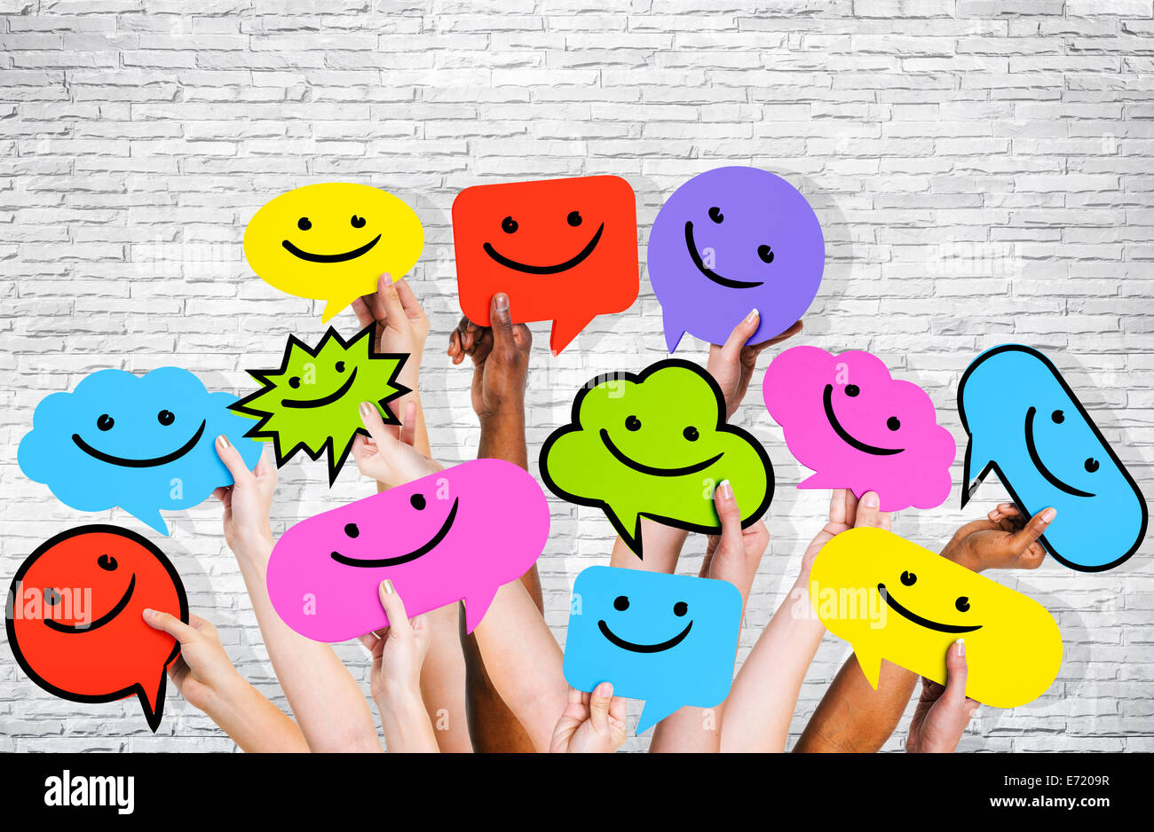 Hände halten Smiley-Gesichter-Symbole. Stockfoto