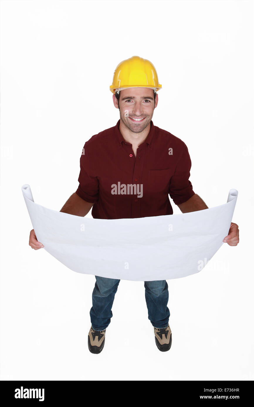 Ein Vorarbeiter, seine Pläne zu überprüfen. Stockfoto