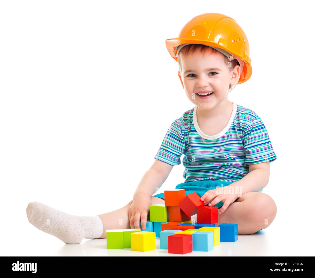 Kind Junge im harten Hut mit bunten Bausteinen Stockfoto