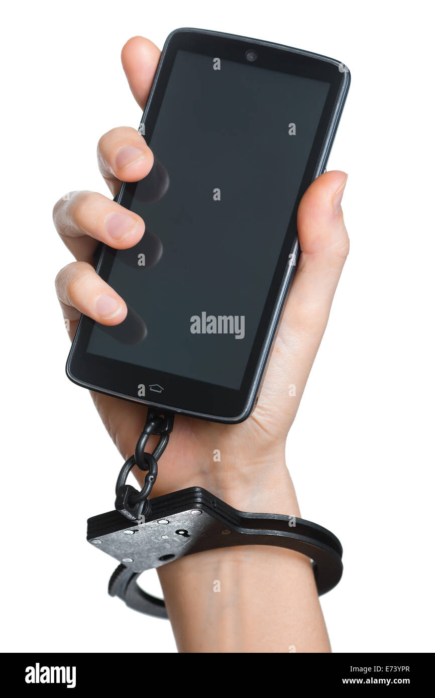 Handy-sucht-Konzept. Smartphone und Handschellen in der Hand, isoliert auf weiss. Stockfoto