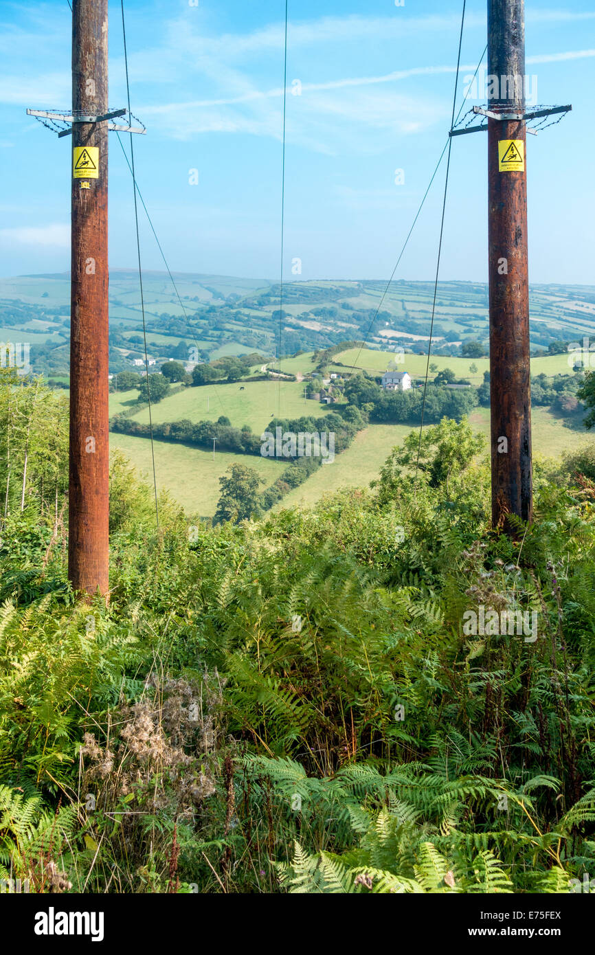Strommasten macht Pylon mit Kabeln erstreckt sich über idyllische englische Tal-Landschaft Stockfoto