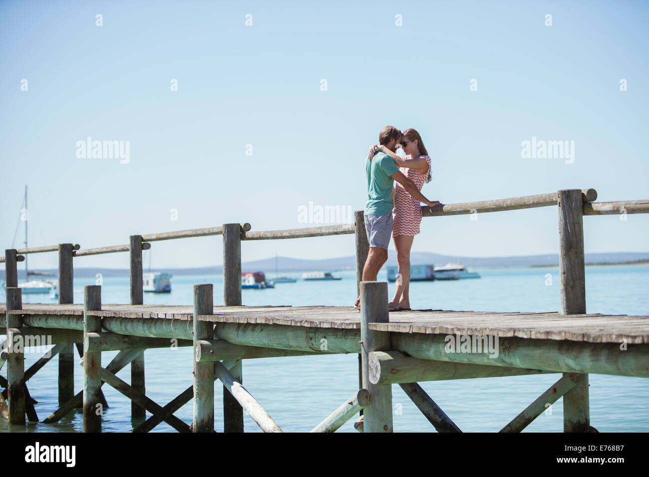 Paar auf hölzerne Dock umarmt Stockfoto