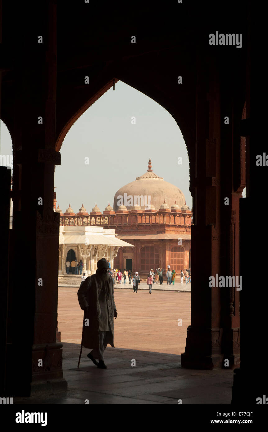 Mann zu Fuß durch einen Torbogen, Jama Masjid, Fatehpur Sikri, Uttar Pradesh, Indien. Stockfoto