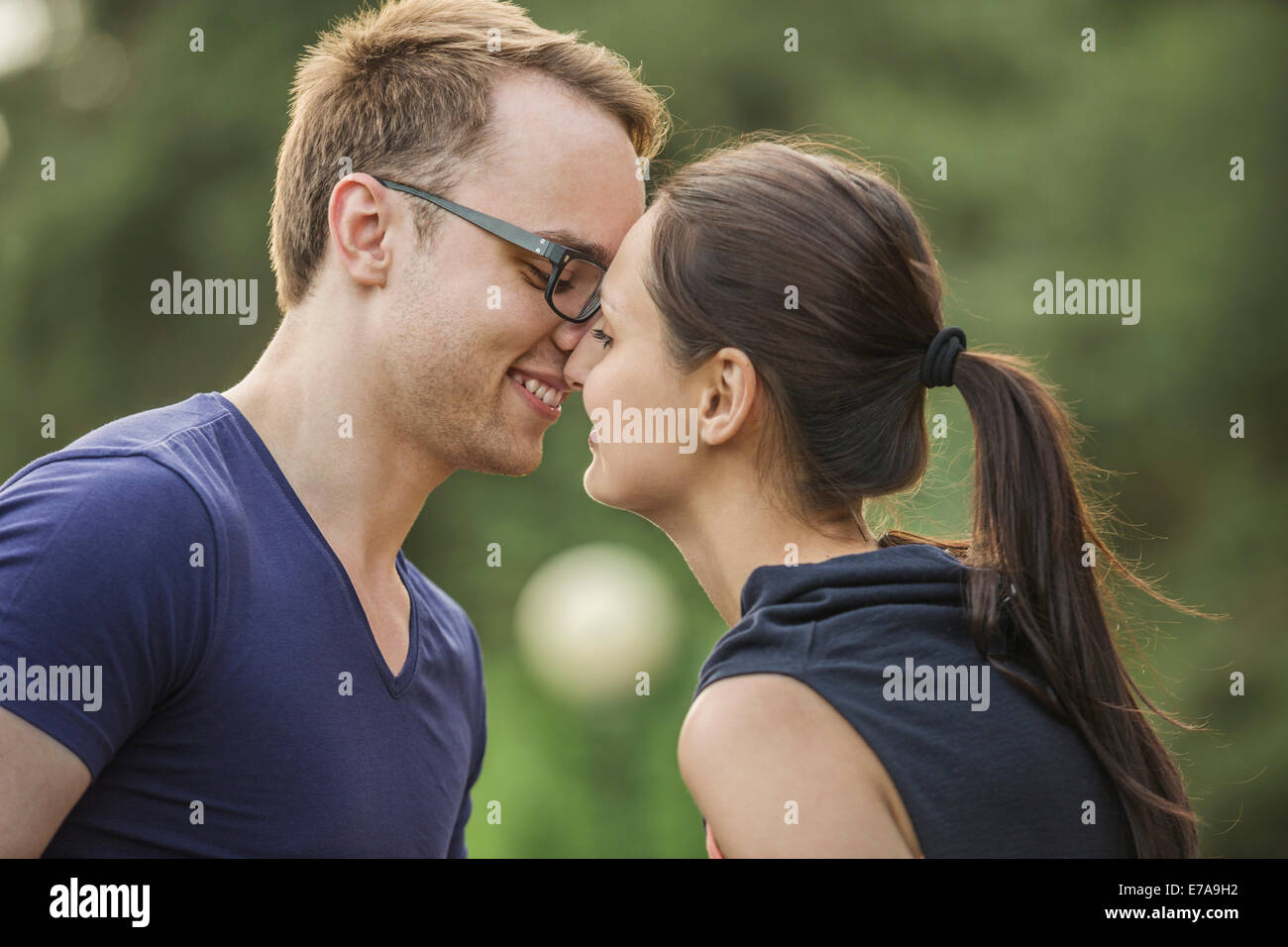 Seitenansicht des Paares reiben Nasen im park Stockfoto