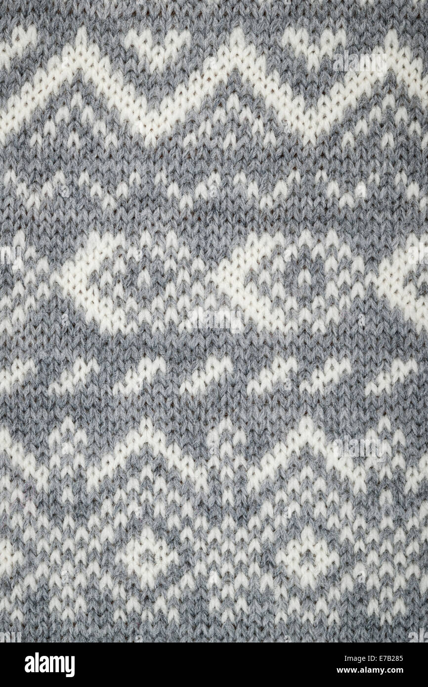 Nahaufnahme von Strick-Hintergrund mit grauen und weißen geometrische Strickmuster Stockfoto