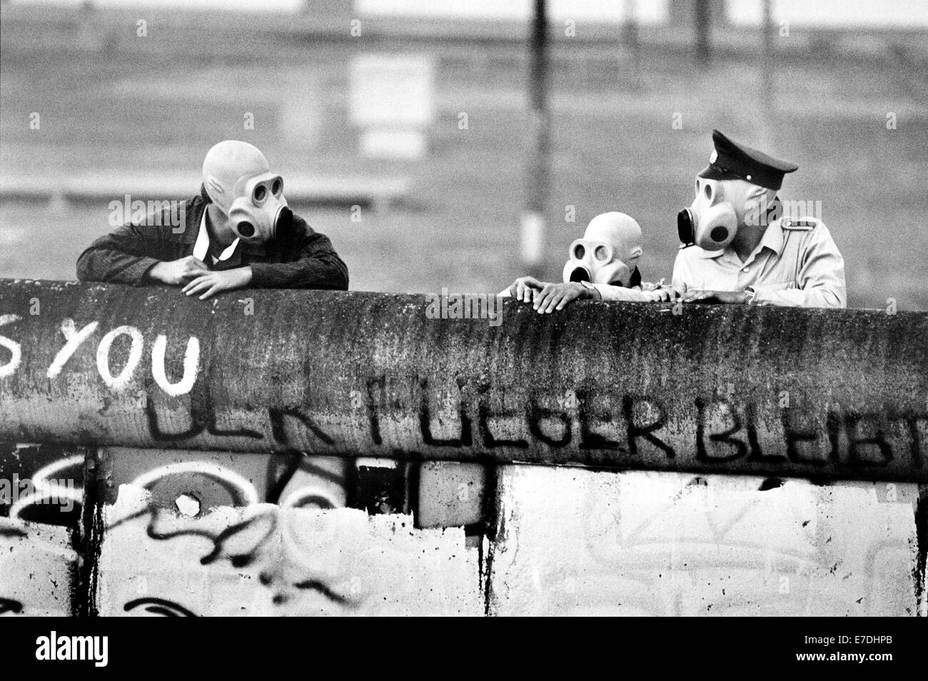 DDR-Grenzsoldaten mit Gasmaske schauen über die Mauer auf dem Potsdamer Platz in Berlin, Deutschland, 21. Juni 1988. Nachdem die Polizei von West-Berliner Besatzern des Dreiecks Lenne Steinen beworfen wurden, wurde Tränengas eingesetzt. Die Enklave nach Ost-Berlin gehörte, aber war Teil des Territoriums Austausches auf 1. Juli 1988, Teil der West-Berliner Bezirk Tiergarten. Foto: Agentur Voller Ernst - kein Draht-SERVICE Stockfoto