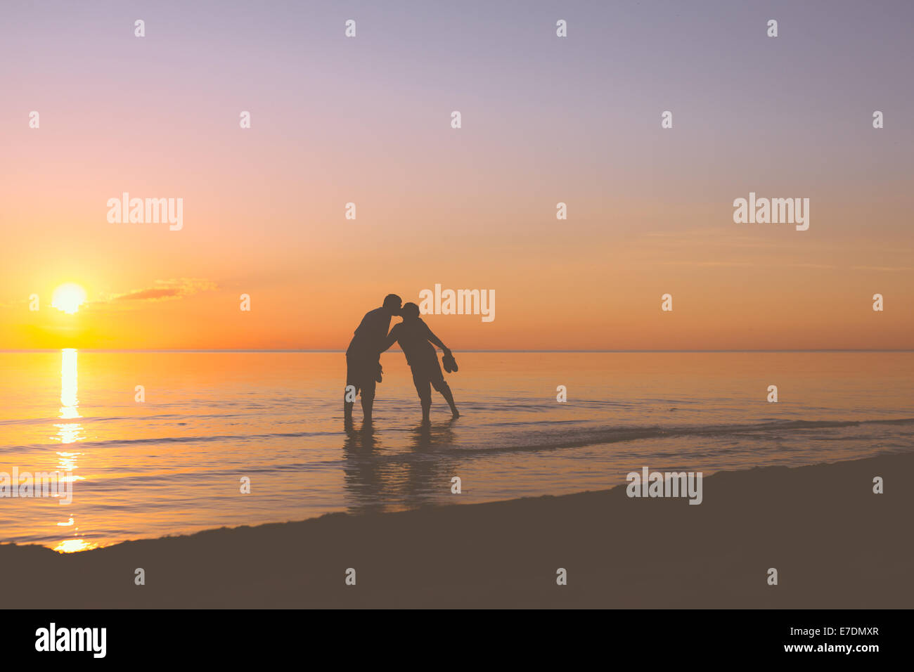 Älteres Paar küssen bei Sonnenuntergang Stockfoto