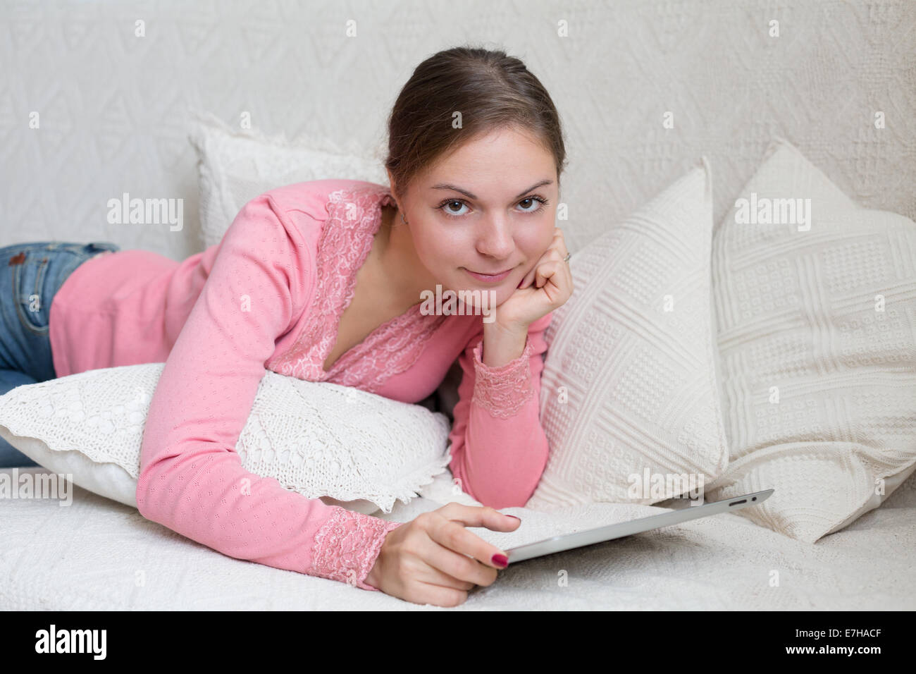 Porträt der Frau 20-25 Jahre alt mit mobilen Gerät in ihren Händen liegen Stockfoto