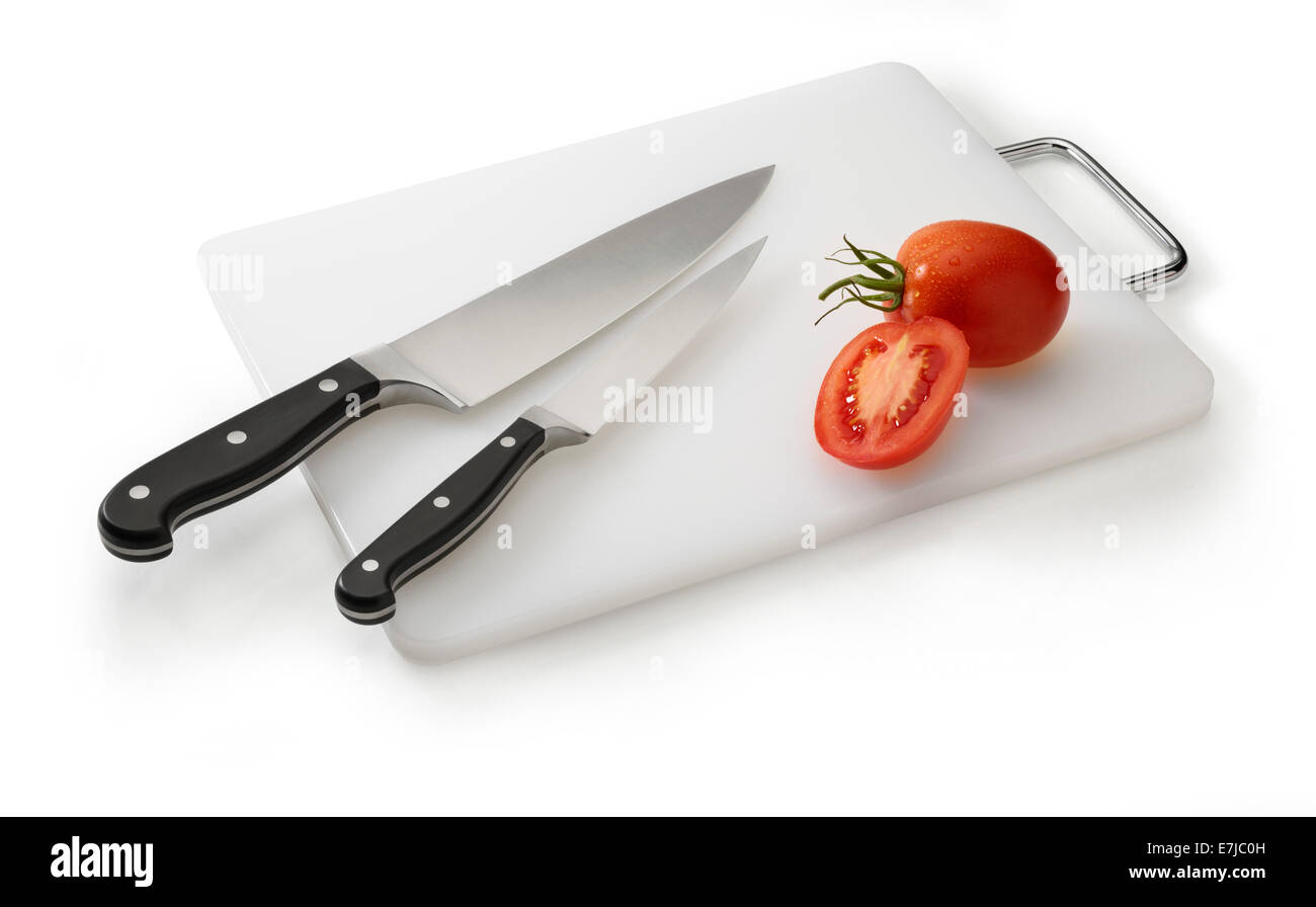 Zwei Messer auf eine weiße Schneidebrett mit Tomaten Stockfoto