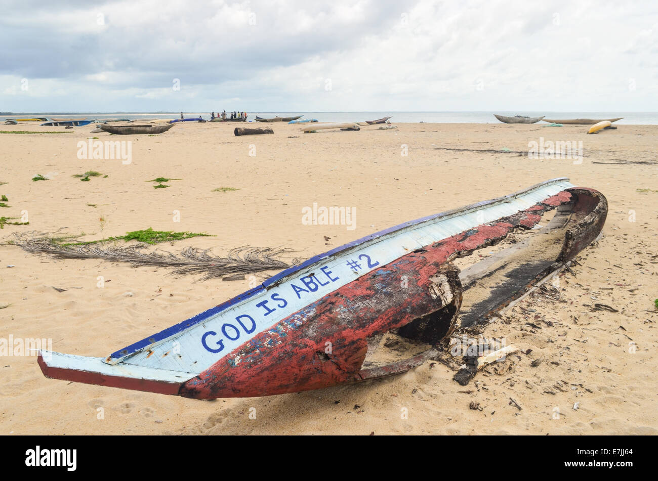 Hölzerne Angelboot/Fischerboot zerstört am Strand Robertsport, Liberia, lesen "Gott ist in der Lage" Stockfoto