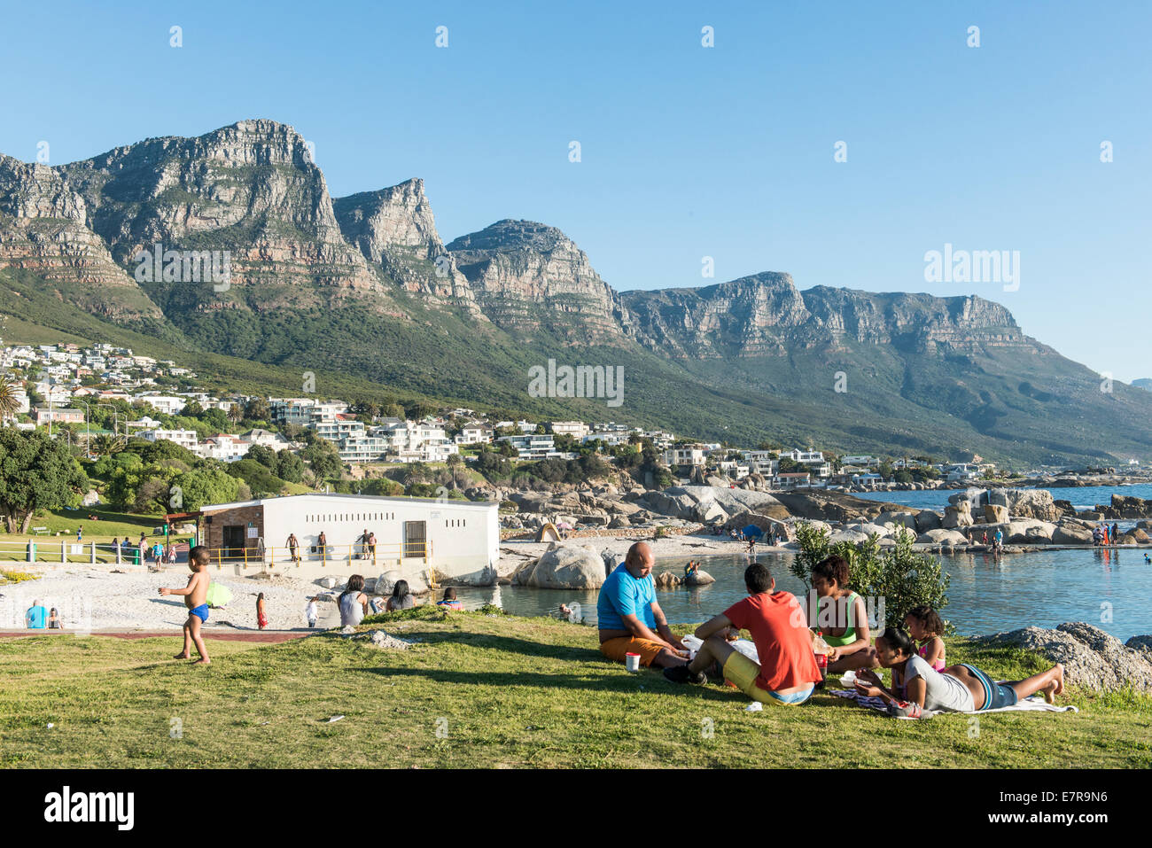 Eine Familie genießt ein Picknick an Camps Bay, Kapstadt, Südafrika Stockfoto