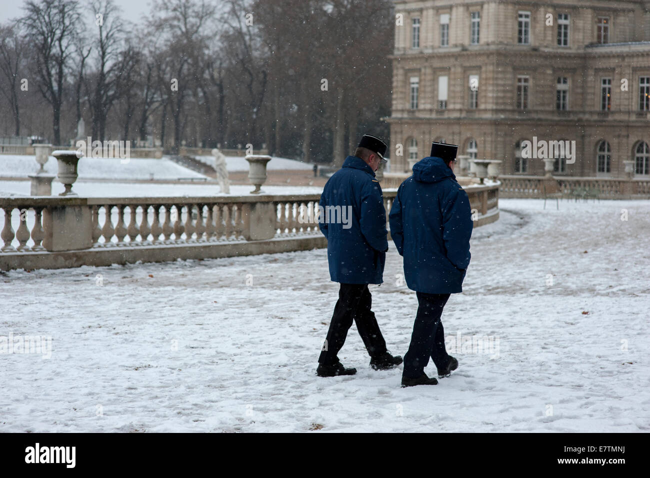 Zwei Paris Gendarmen zu Fuß den Takt in den Jardin du Luxembourg nach einem Winterschnee Stockfoto