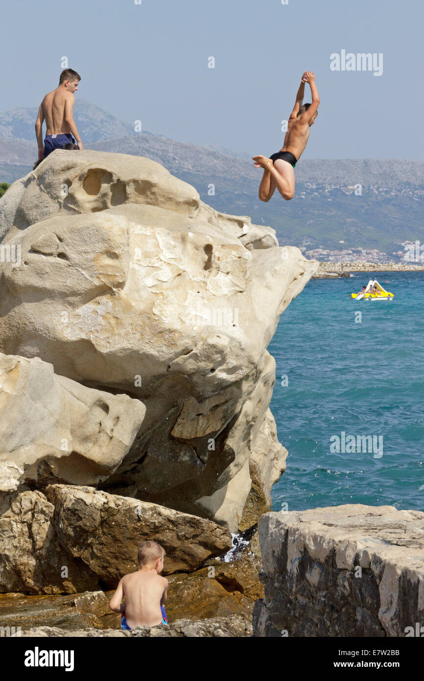 junger Mann von einer Klippe zu springen, Split, Dalmatien, Kroatien Stockfoto