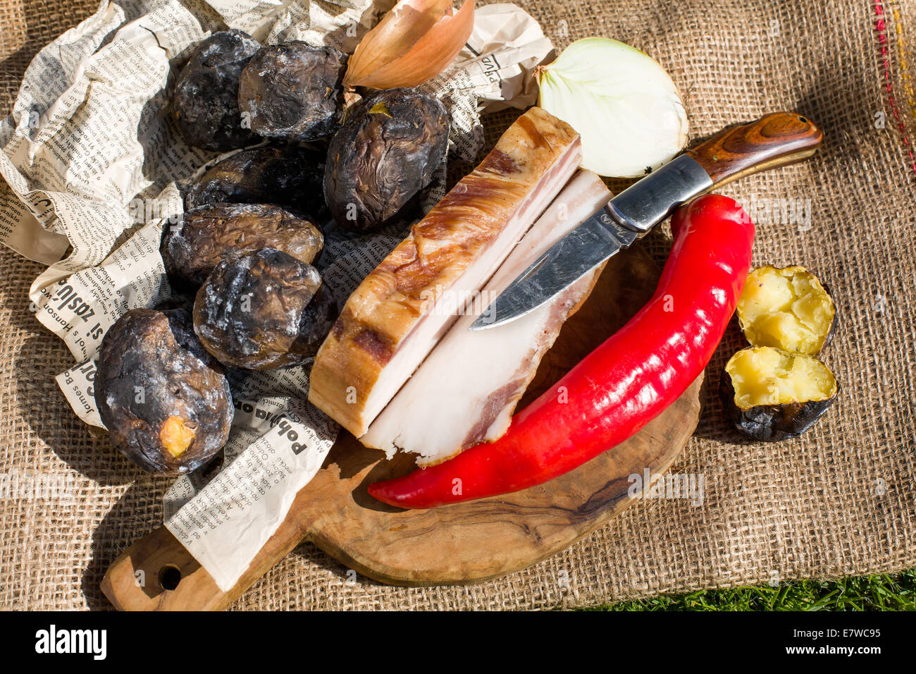 Bauern-Mittagessen - Speck, Kartoffeln in die Glut, Paprika und Zwiebeln gebacken Stockfoto