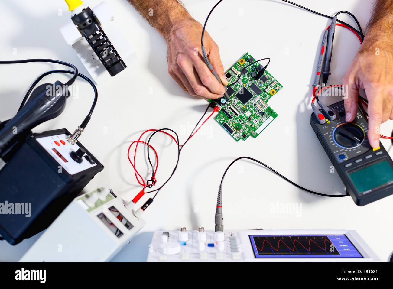 Entwicklung von elektronischen Geräten im modernen Elektronik-Labor auf einem Tisch, Mikroprozessor-Oszilloskop und multimeter Stockfoto