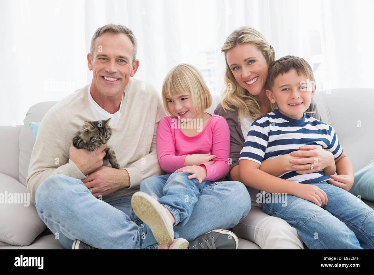 Glückliche Familie Zusammensitzen mit Kätzchen Stockfoto