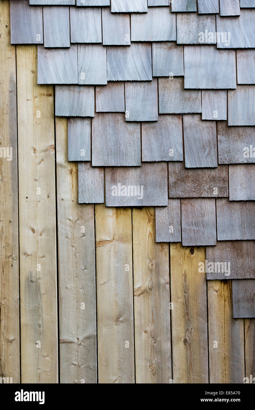 Dachschindeln und Holzplatten am Rande einer Gartenstruktur Stockfoto