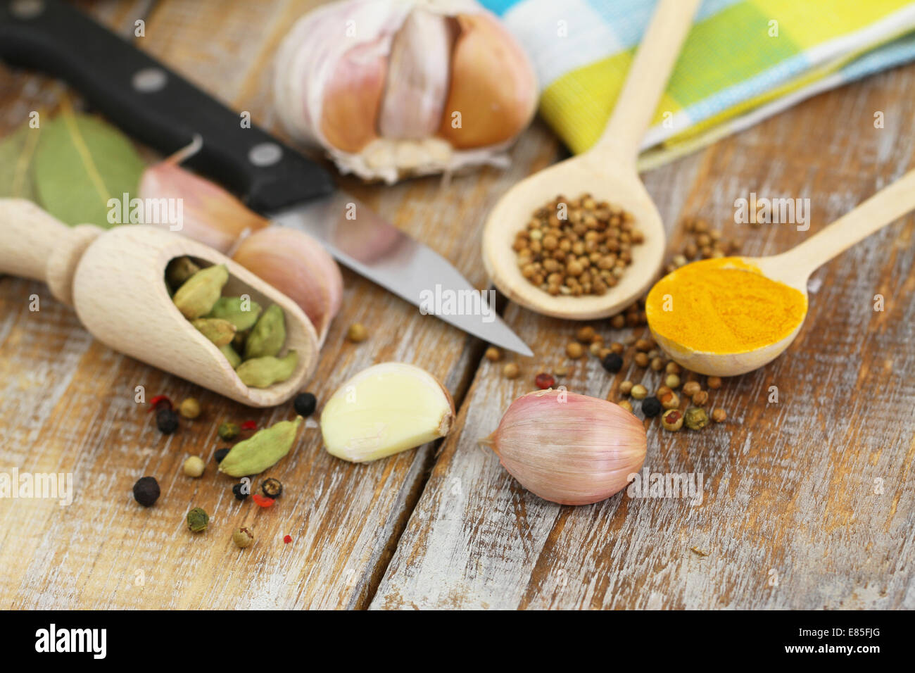 Knoblauch und andere kochen Zutaten und Gewürzen auf Holzuntergrund Stockfoto