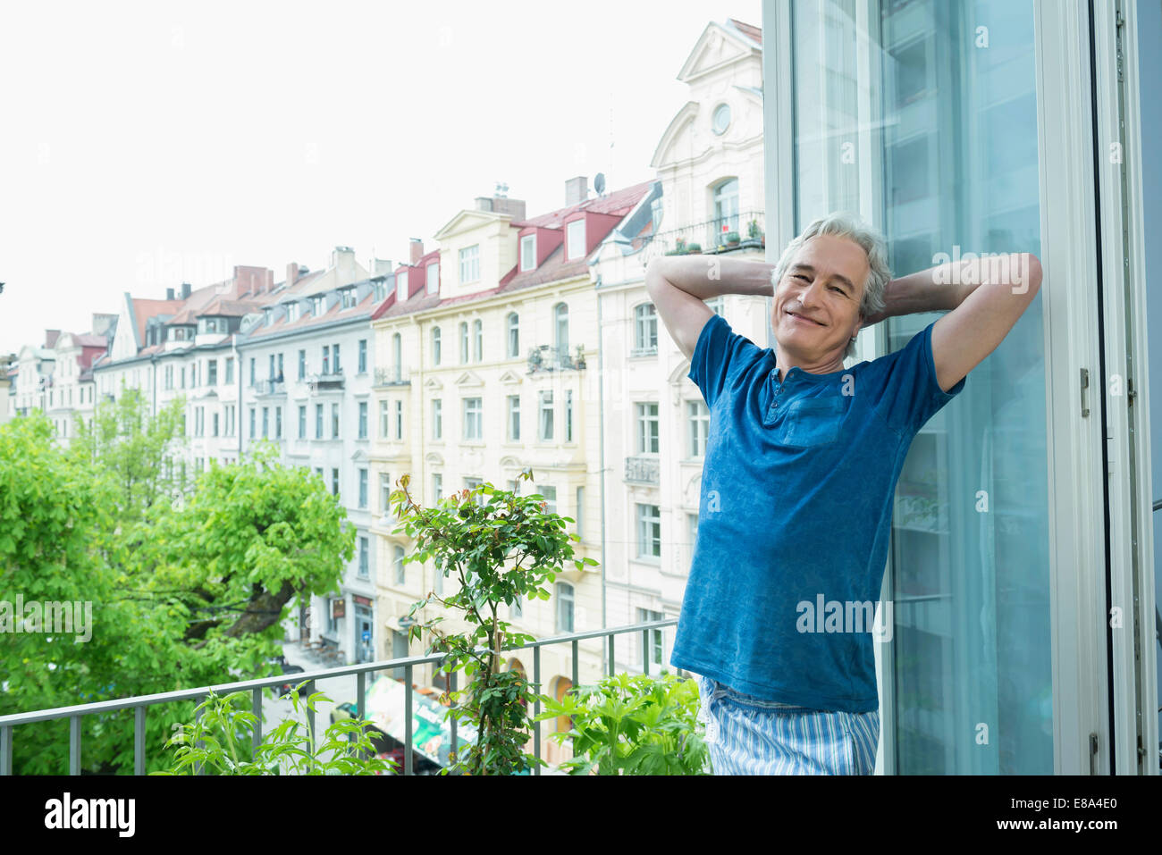 Porträt von reifer Mann stehend auf Balkon, Lächeln Stockfoto