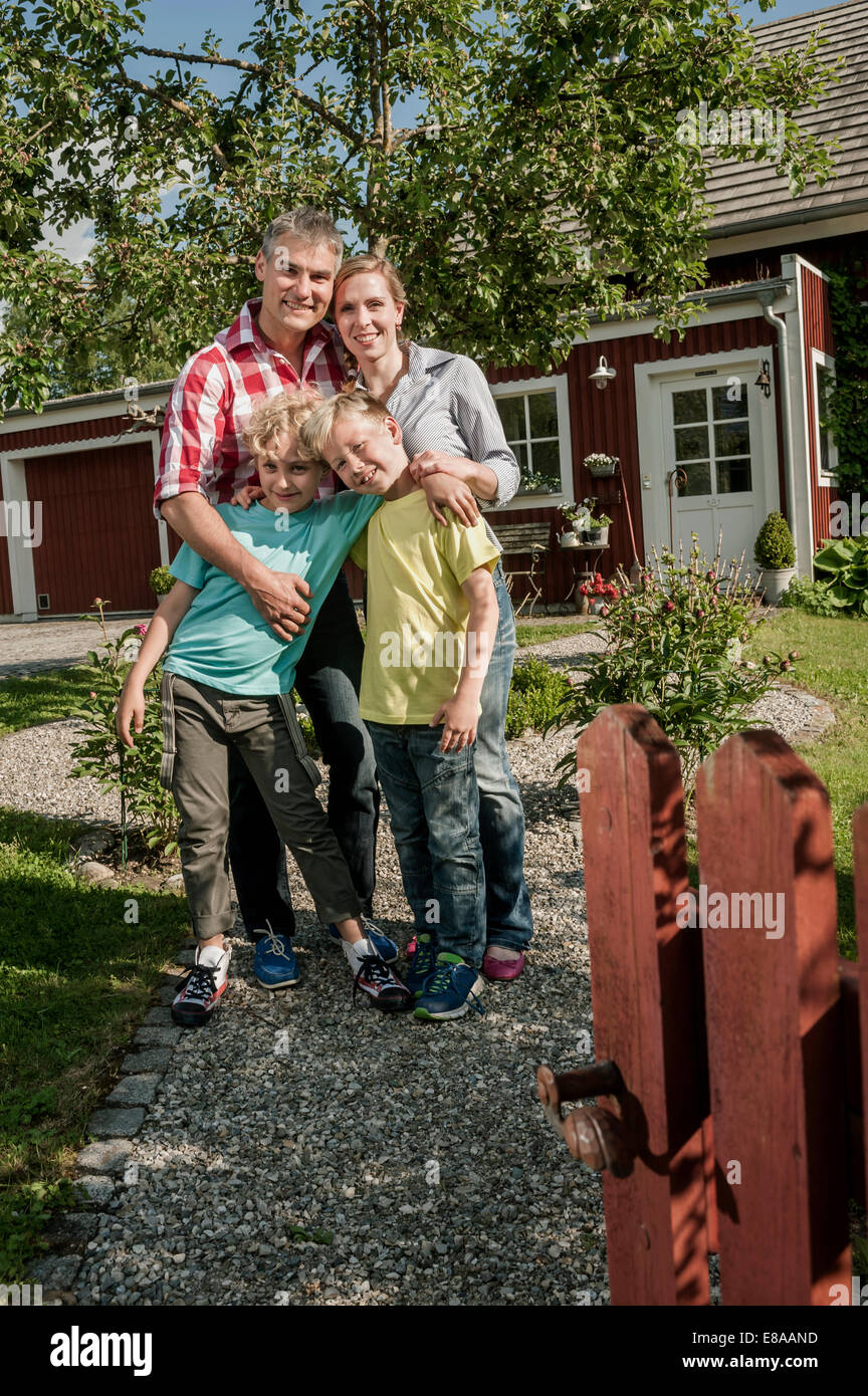 Familie Vater Mutter Jungs Garten Tor neues Zuhause Stockfoto