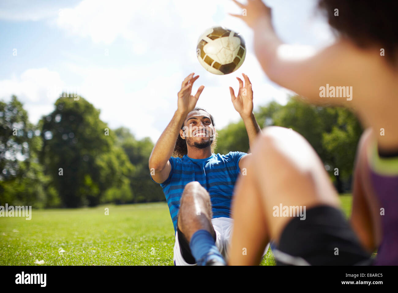 Junges Paar Training mit Fußball im park Stockfoto