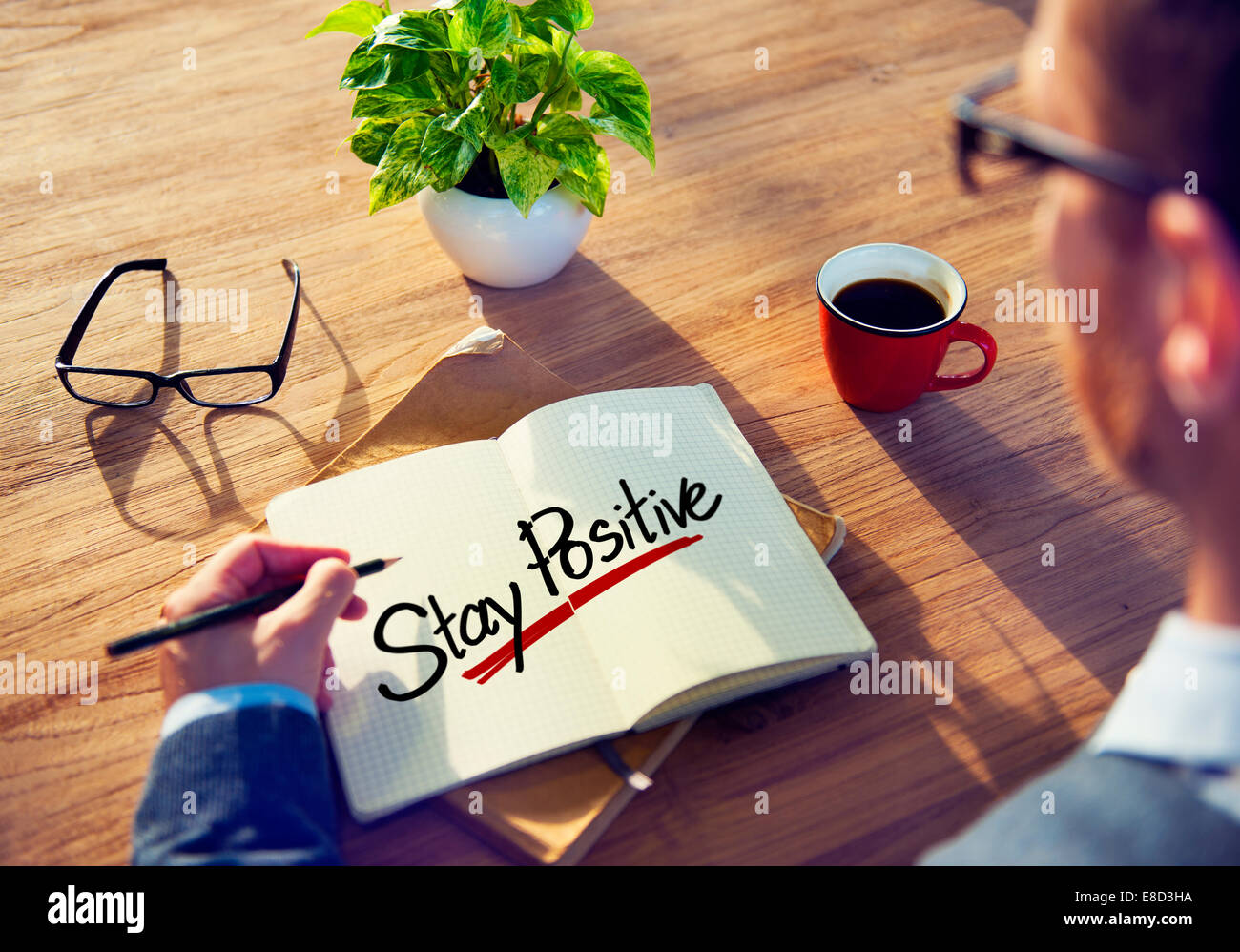 Mann mit eine Notiz und ein einziges Wort bleiben Sie positiv Stockfoto