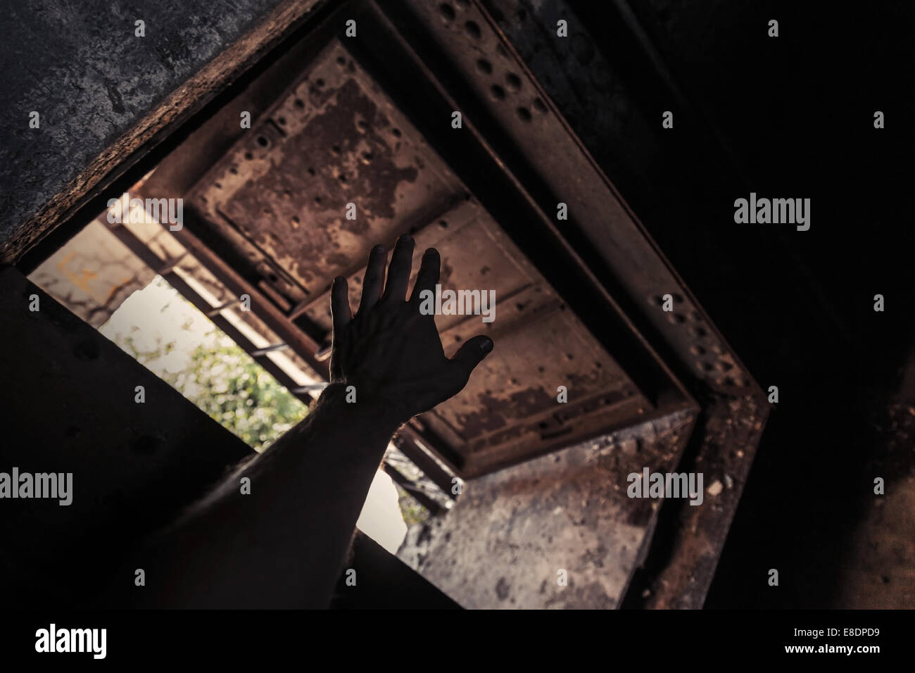 Grunge dunklen Innenraum mit verrosteten Tür öffnen und männliche Hand silhouette Stockfoto