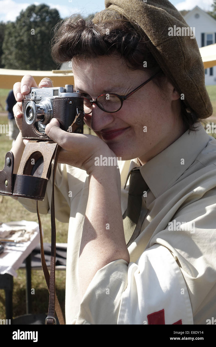 Frau verkleidet als Zweiter Weltkrieg zwei Armee Krankenschwester mit einer Vintage 35mm-Kamera Stockfoto