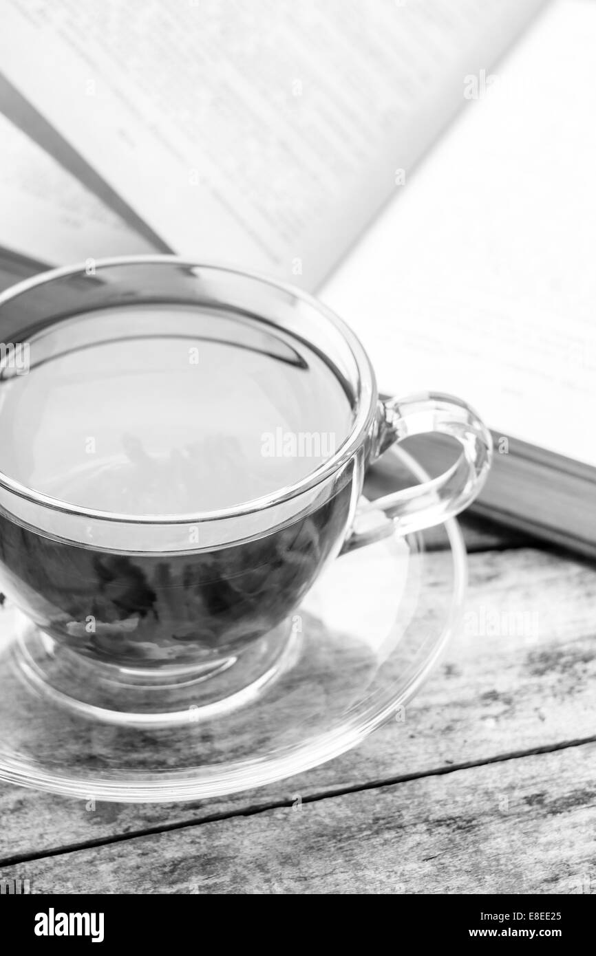 Buch mit Tasse heißen Tee geöffnet. Zeit für Tee Stockfoto