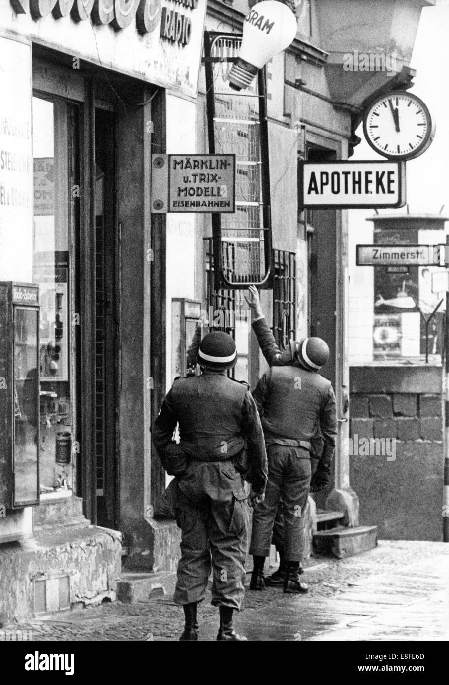 Soldaten der US Army Transport von Bettrahmen in eine Wohnung am Kontrollpunkt Friedrichstraße, Checkpoint Charlie, fordert 1. November 1961 in Berlin. Von dieser Wohnung hat der US-Armee einen perfekten Blick auf die Ost-Berliner Seite der Grenze. Vom 13. August 1961, der Tag der Errichtung der Mauer, waren bis zum Fall der Berliner Mauer am 9. November 1989 der Bundesrepublik und der DDR durch den "Eisernen Vorhang" zwischen Ost und West getrennt. Stockfoto