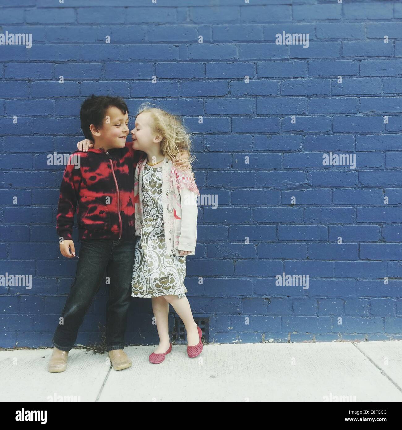 Porträt eines Jungen und Mädchen mit ihren Armen um einander Stockfoto