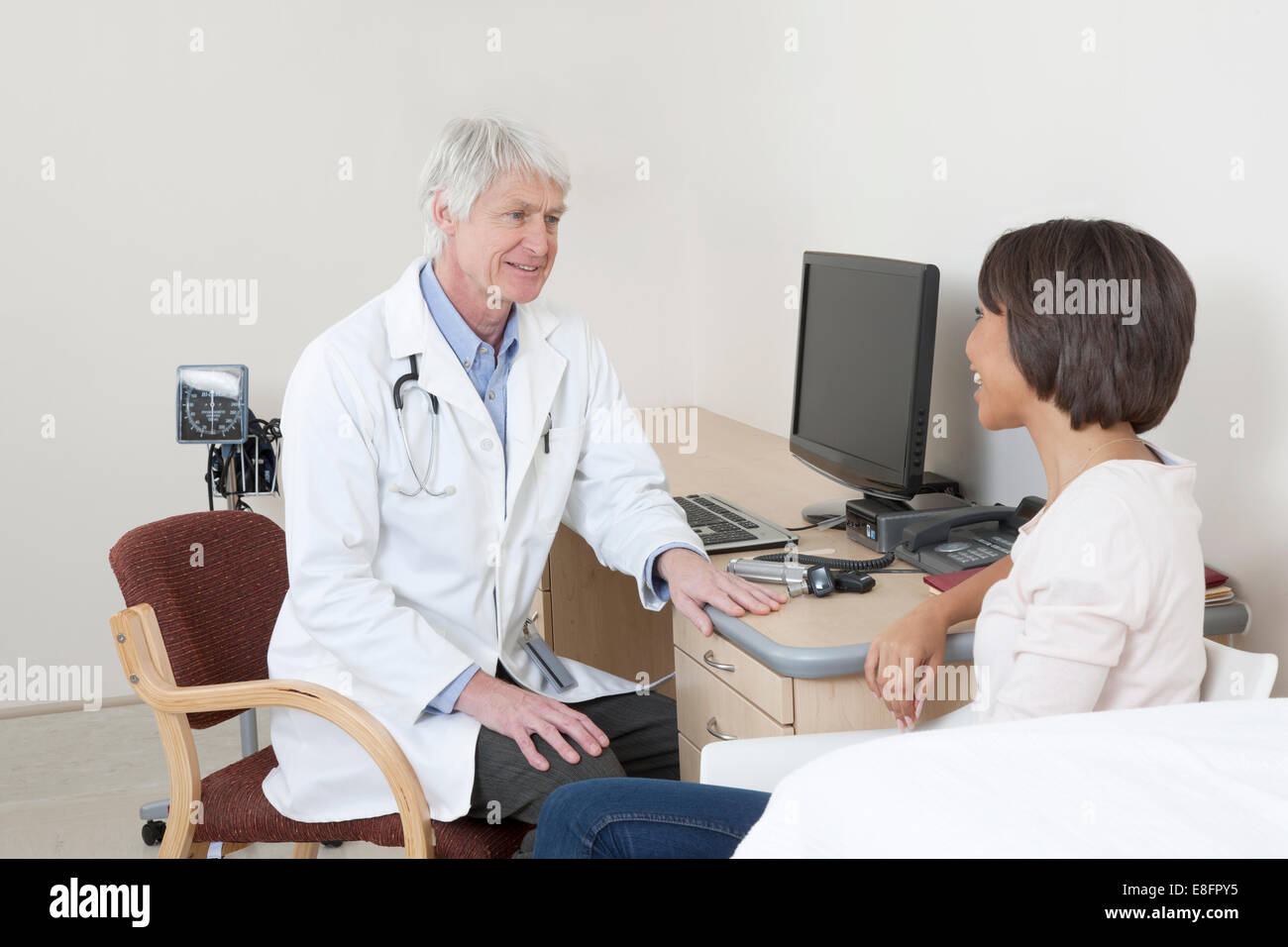 Arzt im Gespräch mit Patienten im Untersuchungsraum Stockfoto