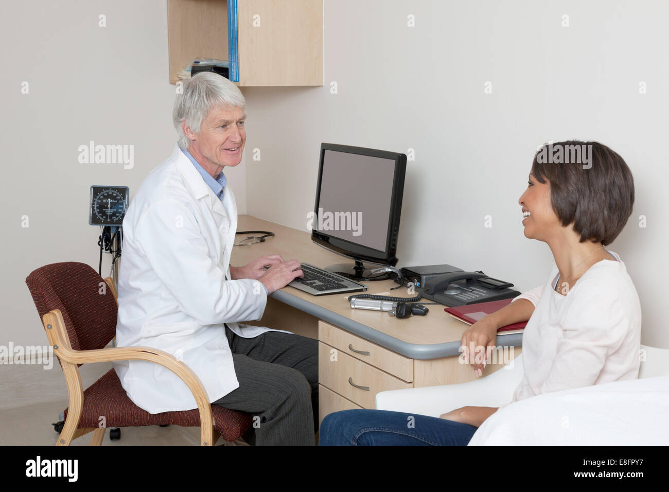 Arzt im Gespräch mit Patienten im Untersuchungsraum Stockfoto