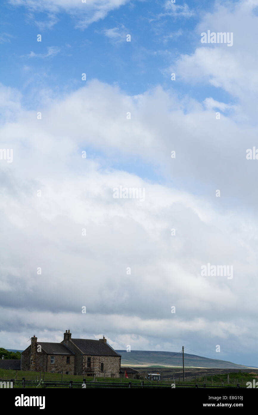 Bewölkter Himmel mit Bauernhaus Stockfoto