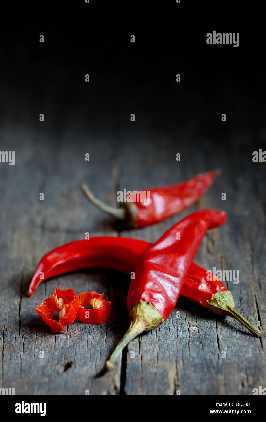 Rote scharfe Chilischoten über hölzerne Hintergrund Stockfoto