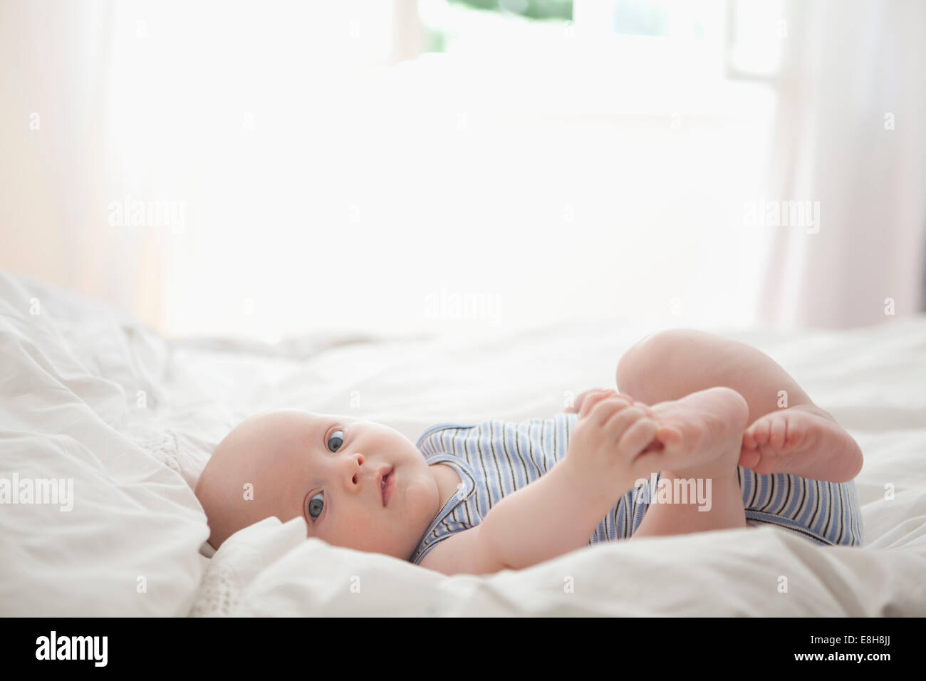 Deutschland, München, (2-5 Monate) Baby Boy auf Bett, Porträt Stockfoto