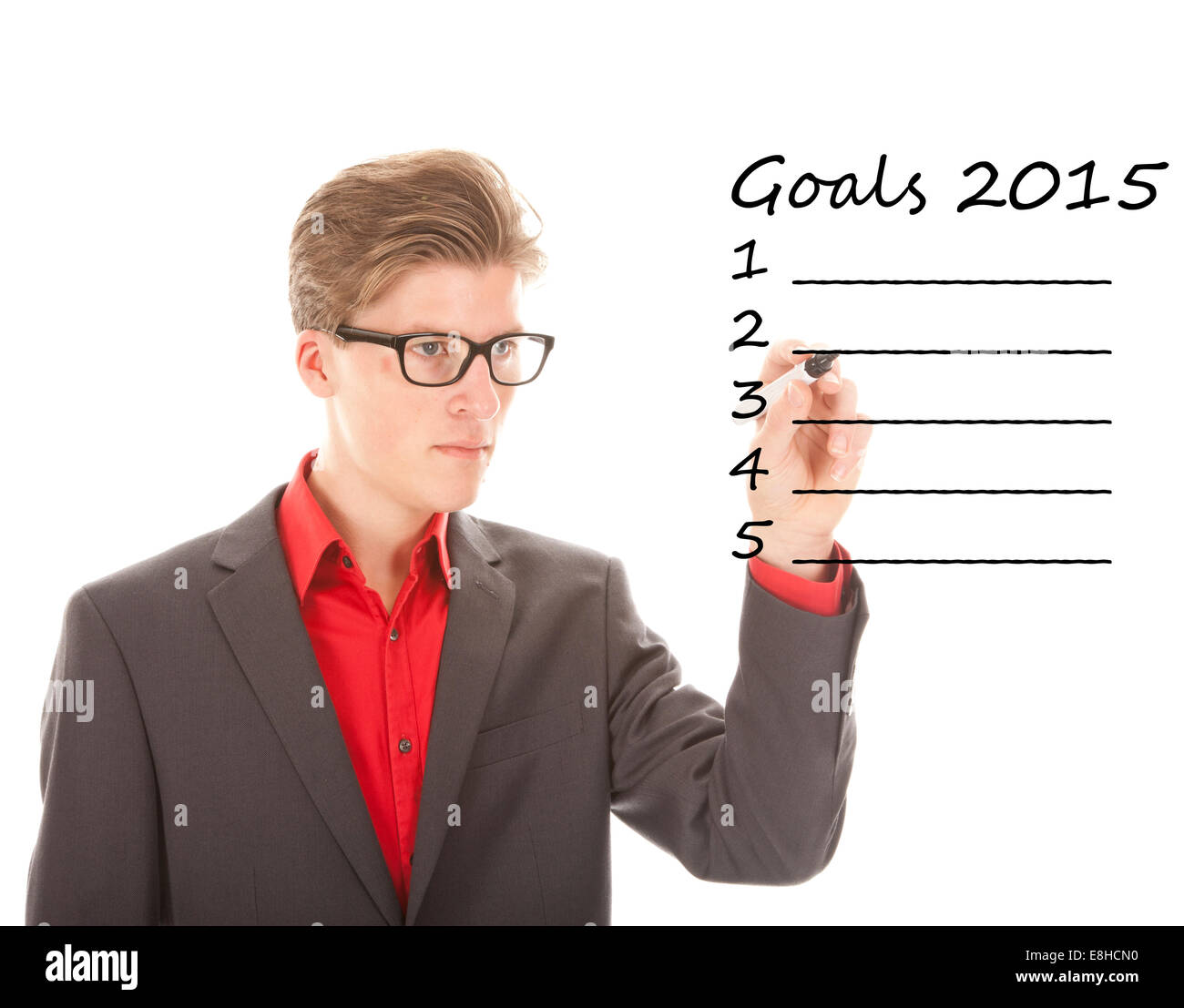 Junger Mann schreiben Ziele 2015 isoliert auf weißem Hintergrund Stockfoto