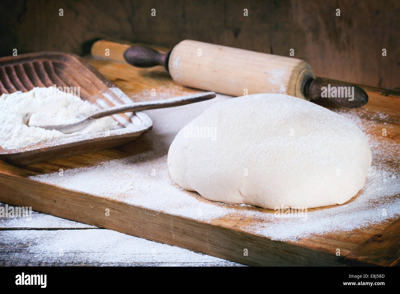 Brot backen. Teig auf Holztisch mit Mehl und Vintage Nudelholz Stockfoto