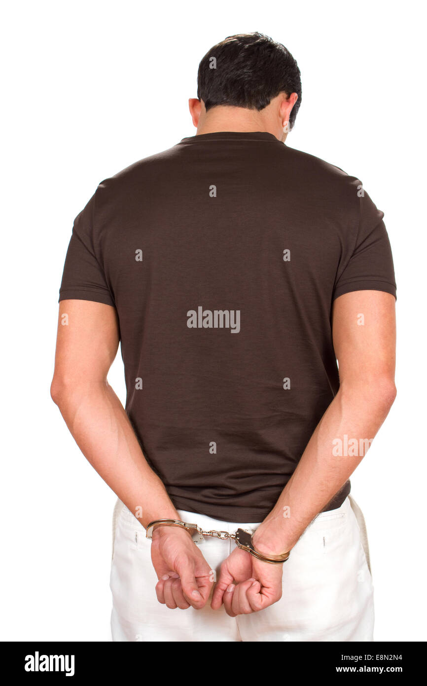 Verhaftet kriminelle steht mit den Händen hinter seinem Rücken mit Handschellen gefesselt. Stockfoto